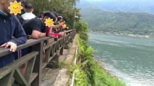 Youths resting beside the lake after cycling