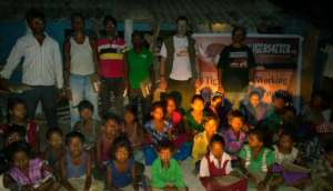 Education packs distributed in a village at night
