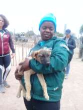 Tinyiko loving puppies on an outreach day!