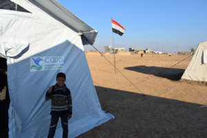 One of the students beside a tent