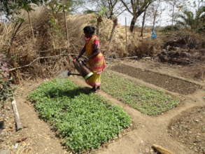 A Mother Watering the Kitchen Garden