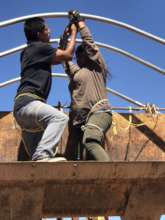 Team work for getting the hoop house roof in place