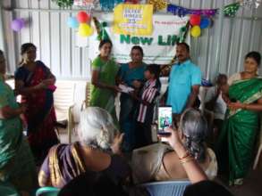 Selvam receiving the cheque from his sponsor