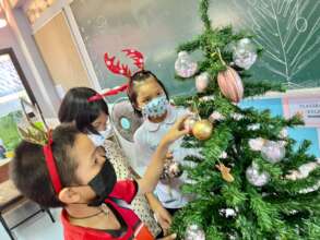 Decorating their first Christmas Tree