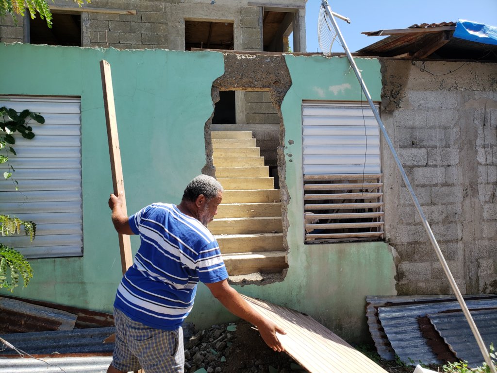 Illario using pieces wood as a makeshift door