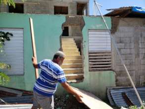 Illario using pieces wood as a makeshift door