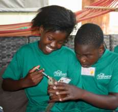 children feeding a baby squirrel