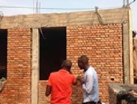 Inspecting the new brick walls.