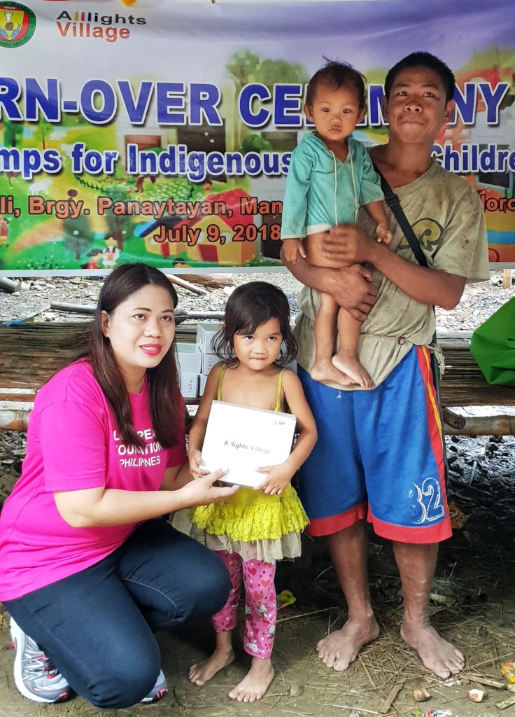 One of Mr. Bugkat's children receives a solar lamp