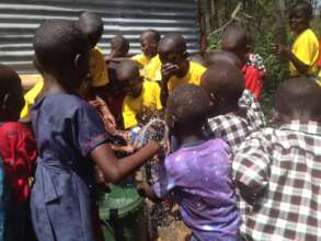 Children at Agape school playing with water