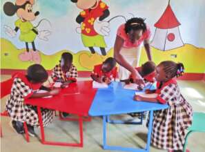 Teacher Lillian instructing pupils in class