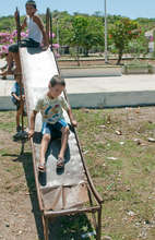 Children of Otates, Mexico "play" on rusted slide