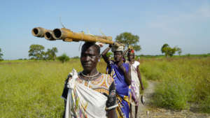 Carrying well drilling equipment.