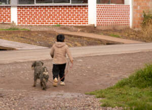 Child with his dog in a village
