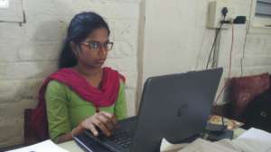 Academic coordinator using a laptop