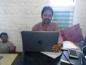 Academic coordinator using a laptop