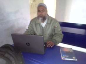 Academic coordinator using a laptop