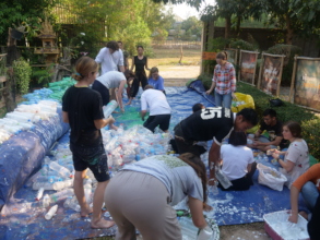 Students paint bottles for the plastic project