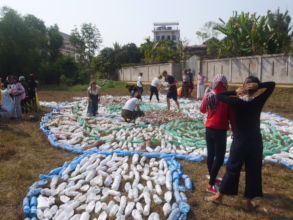 Students arranging plastic bottles