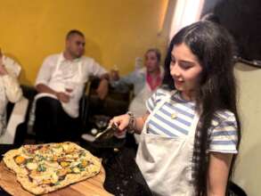 Making pizza during a fundraiser on the rooftop