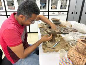 Elias Zaldivar reconstructing a ceramic
