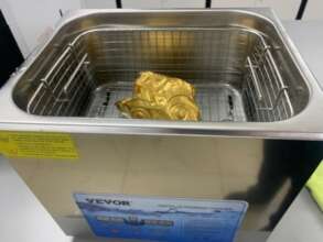 Gold breast plate being cleaned