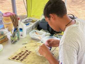 A student cleaning and photographing materials