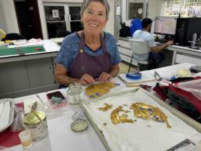 Rae Beaubien working with gold breastplate