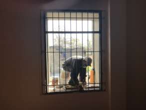 Working to remove the rust from the window bars