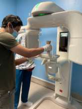 Arturo cleaning an artifact beofre taking photos