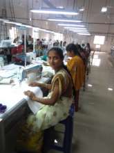 Suma beside a tailoring machine