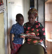 literacy volunteer reading with a child