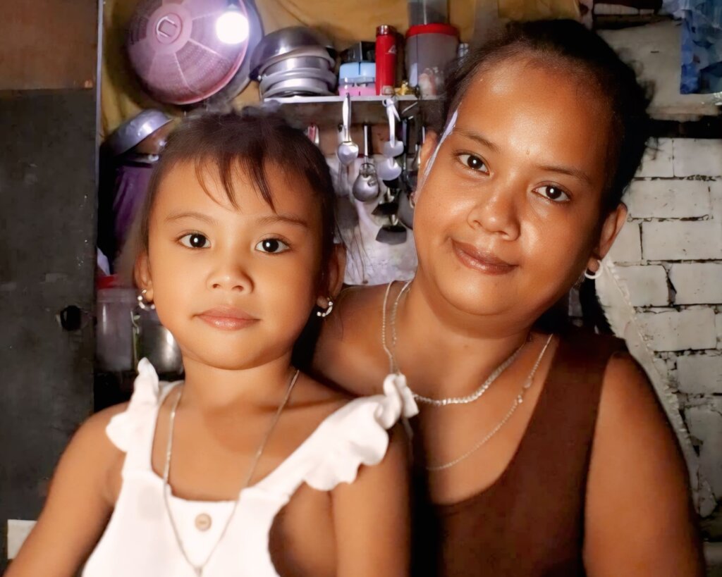 Charlene & her mom, Ana, inside their Payatas home
