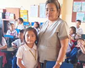 Maica poses for a photo with her homeroom teacher