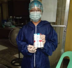 A health worker with Vitamin Angels supplies
