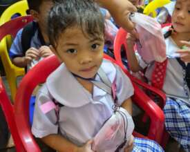 A Lupang Pangako learner clutching her hygiene kit