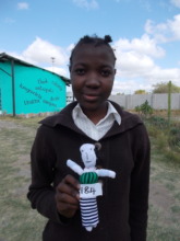 Langilihle posing with her handmade doll in 2015