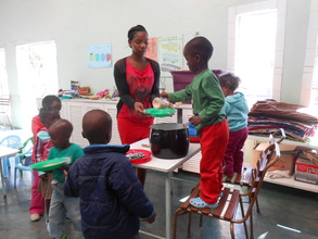 Little ones take turns serving lunch