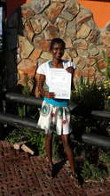 Sibahle proudly holds her Advanced Level report