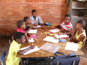 Zimkids working on wall mural designs