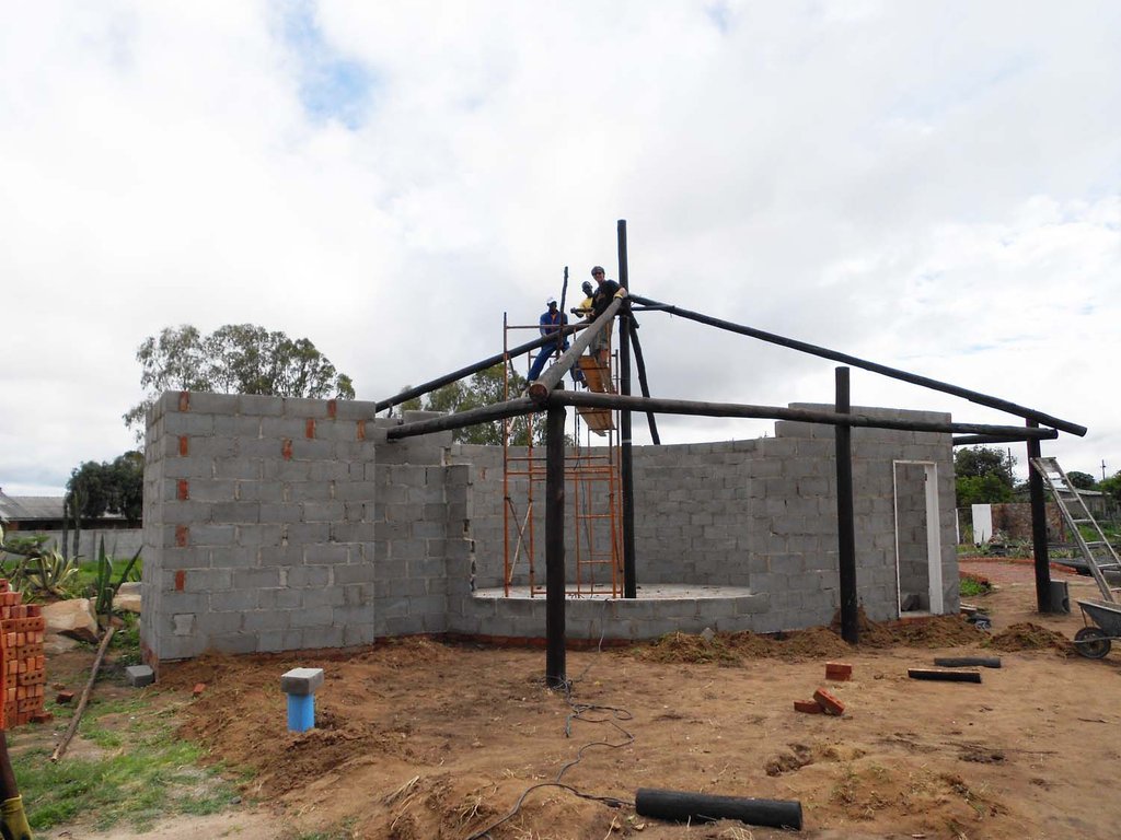 Foster, TInashe and Dennis put up roof structure