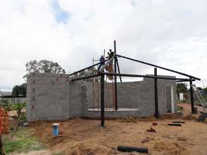 Foster, TInashe and Dennis put up roof structure
