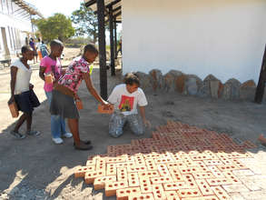 Kids bringing bricks help build our path