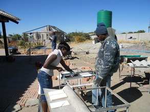 Sithibisiwe cutting tiles for bathrooms