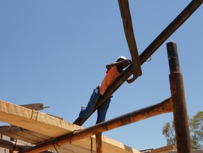 Tinashe bolting gumpole to Tech center roof