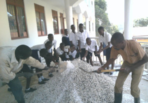 A group of boys chat with the terrazzo installers