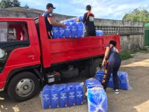 Fire Men carrying water containers to refugees