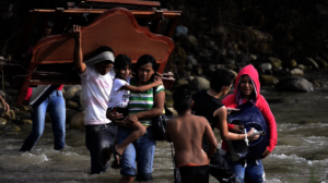 Venezuelan Refugees Crossing River into Colombia