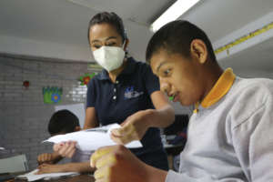 Educator assiting a beneficiary