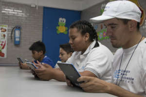 Benficiaries working with tablets